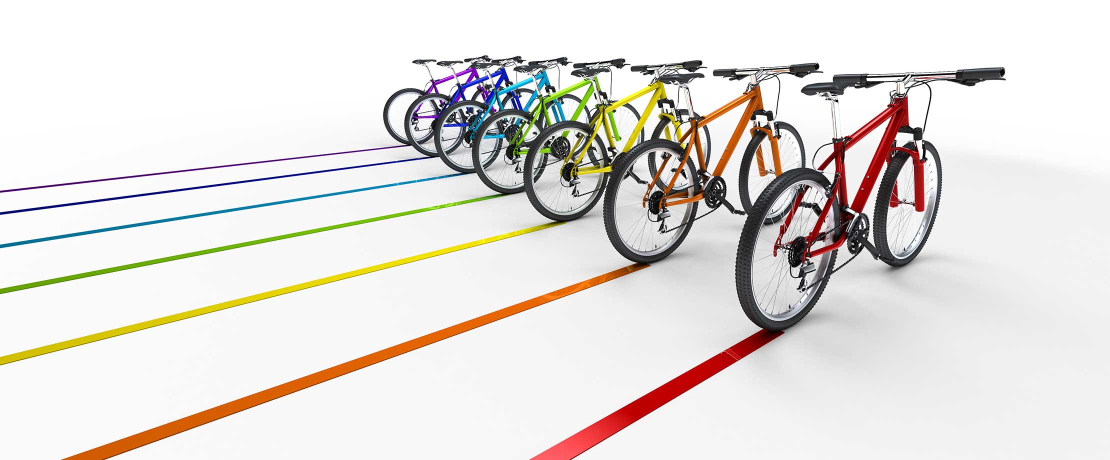 Die beste Versicherung für Fahrräder & E-Bikes Hintereinanderstehende Fahrräder in den Regenbogenfarben fahren schräg nach hinten und ziehen bunte Spuren nach sich.